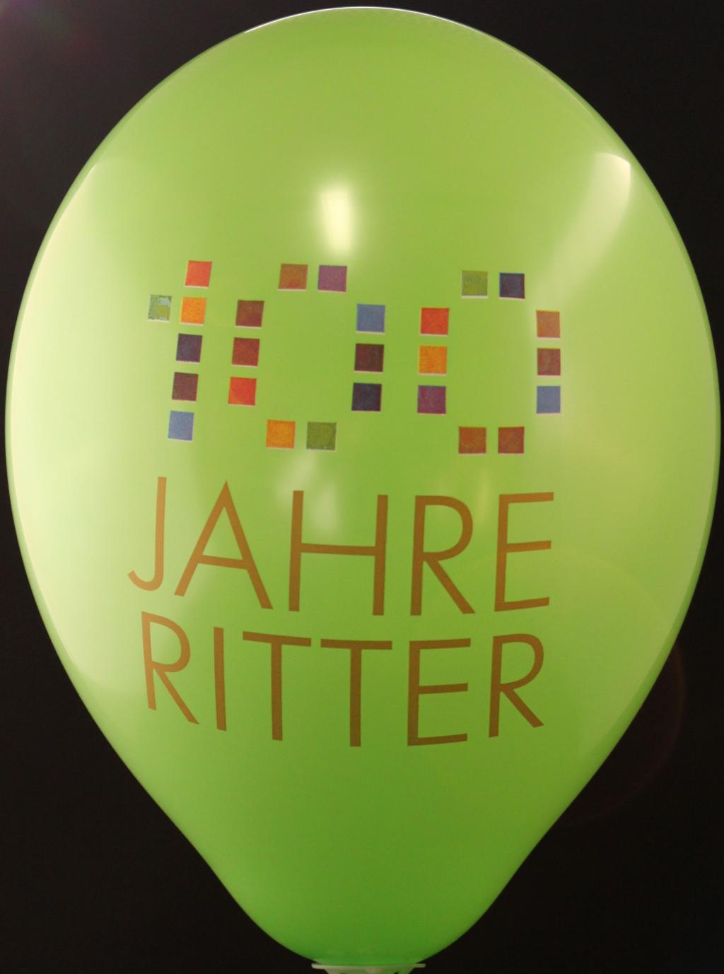 Multicolour '100 Jahre Ritter' logo printed on a green balloon
